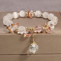 KarmaRipples Katzenaugen-Armband mit rosa Edelsteinen und Peace-Zeichen