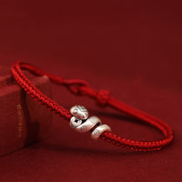 KarmaRipples handgefertigtes gewebtes Armband aus 999 Sterlingsilber zum Jahr der Schlange mit Münzschutz aus Bronze