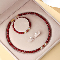 KarmaRipple's Schmuckset mit Anhänger, Halskette, Armband und Ohrringen aus 925er Sterlingsilber mit authentischer Zinnoberperle