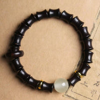 KarmaRipples Peace-Armband aus Ebenholz, grünem Sandelholz, schwarzem Rosenholz und Bambus