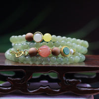 KarmaRipples authentisches Armband aus Hetian-Jade, Bernstein, Lotus, rotem Achat und Glücksbringer