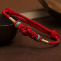 KarmaRipples Armband mit roter Schnur und Jade-Glückskette