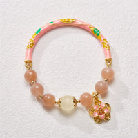 KarmaRipples authentischer Sonnenstein-Armreif mit goldener Jadeblume aus Seide und Talisman