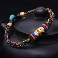 KarmaRipples handgefertigtes tibetisches Armband mit acht Fäden, geflochtener Bronzemünze und Glücksschnur
